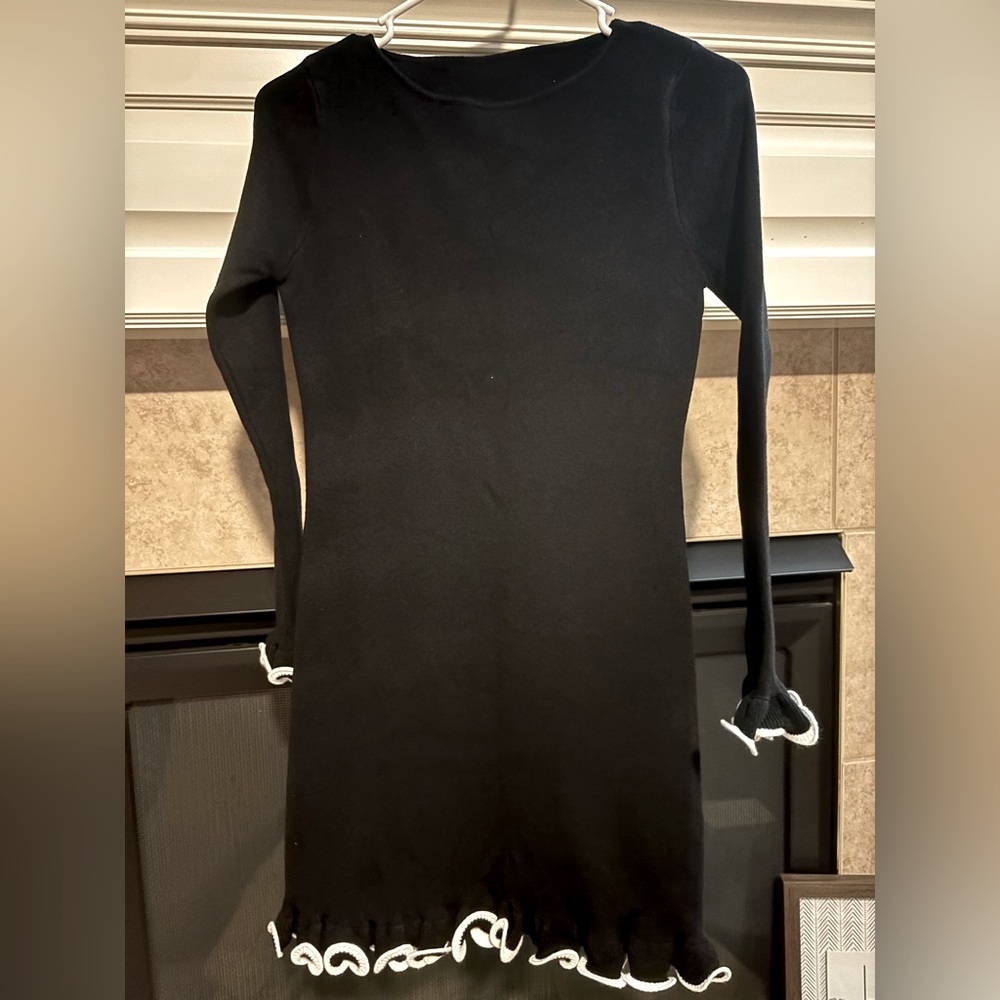 Long sleeve black dress with white details on sleeves and bottom